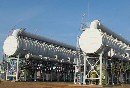 How do sand filters prevent corrosion of heat exchangers?